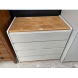 A MODERN CHEST OF THREE DRAWERS