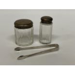TWO HALLMARKED SILVER TOPPED DRESSING TABLE JARS & FURTHER UNMARKED SUGAR TONGS (3)
