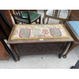 AN OAK JACOBEAN STYLE MINIATURE BLANKET CHEST WITH CARVED PANELS AND UPHOLSTERED TOP, 27" WIDE