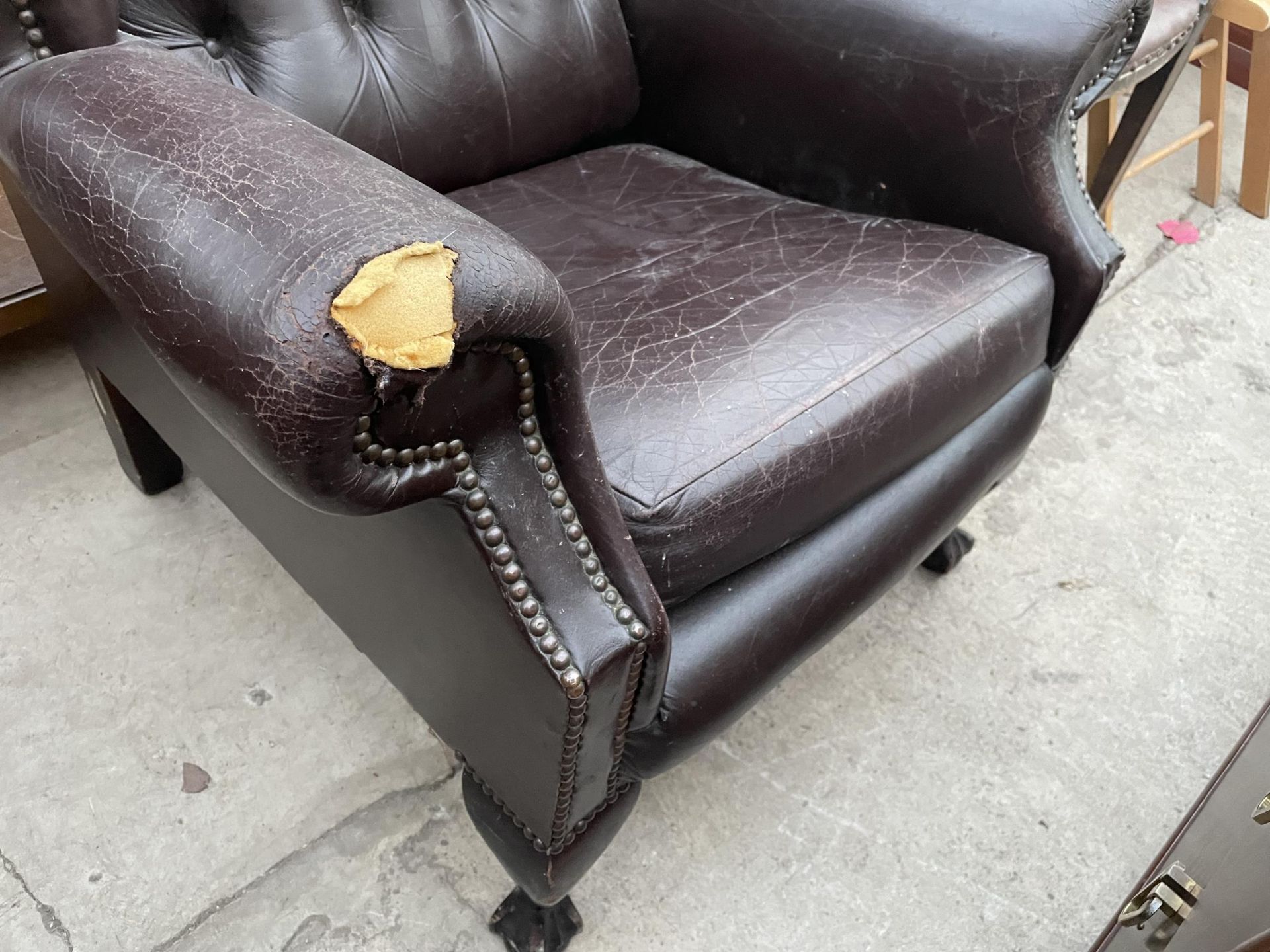 A BROWN FAUX LEATHER WINGED FIRESIDE CHAIR ON FRONT CABRIOLE LEGS, WITH BALL AND CLAW FEET - Image 3 of 4