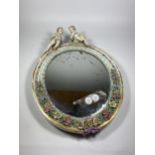 A CONTINENTAL PORCELAIN MIRROR WITH CHERUB AND FLORAL DESIGN