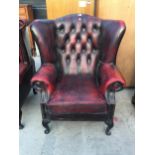 A WINCHESTER FURNITURE OXBLOOD WINGED FIRESIDE CHAIR ON CABRIOLE LEGS