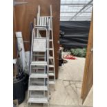 FOUR VARIOUS LADDERS TO INCLUDE A SIX RUNG WOODEN STEP LADDER, TWO ALUMINIUM STEP LADDERS AND A