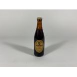 A MINIATURE GUINNESS EXTRA STOUT BOTTLE