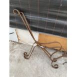 A PAIR OF CURVED WROUGHT IRON BENCH ENDS
