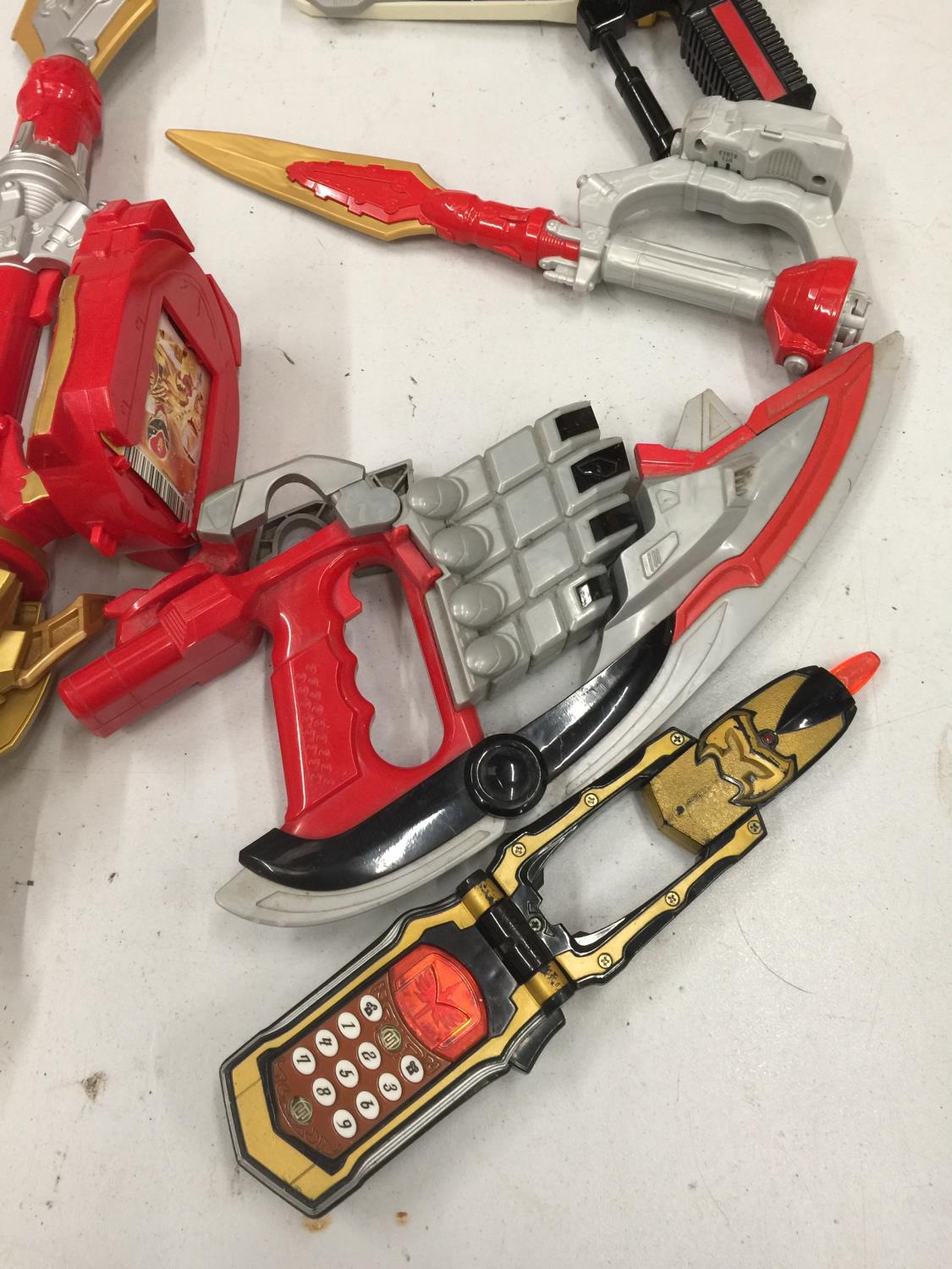A QUANTITY OF POWER RANGER WEAPONS AND ACCESSORIES TO INCLUDE A PHONE, GUN, SWORDS, ETC - Image 2 of 3