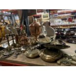 A LARGE QUANTITY OF BRASS AND COPPER ITEMS TO INCLUDE CANDLESTICKS, SMALL WARMING PANS, A BELL,