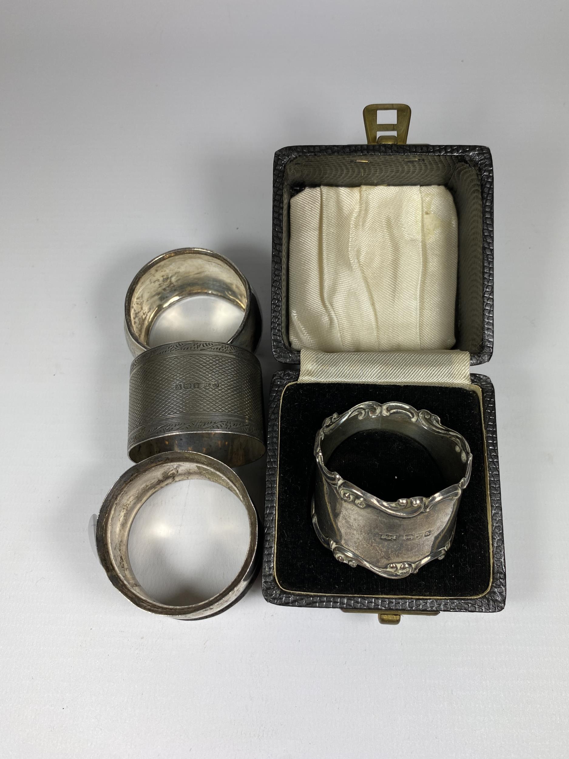 FOUR ASSORTED HALLMARKED SILVER NAPKIN RINGS TO INCLUDE A BOXED CHESTER HALLMARKED EXAMPLE, TOTAL