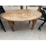 AN OVAL PINE AND BEECH COFFEE TABLE