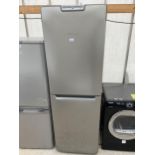 A SILVE HOTPOINT UPRIGHT FRIDGE FREEZER