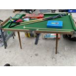 A SMALL SNOOKER TABLE COMPLETE WITH BALLS, TRIANGLE AND CUES ETC
