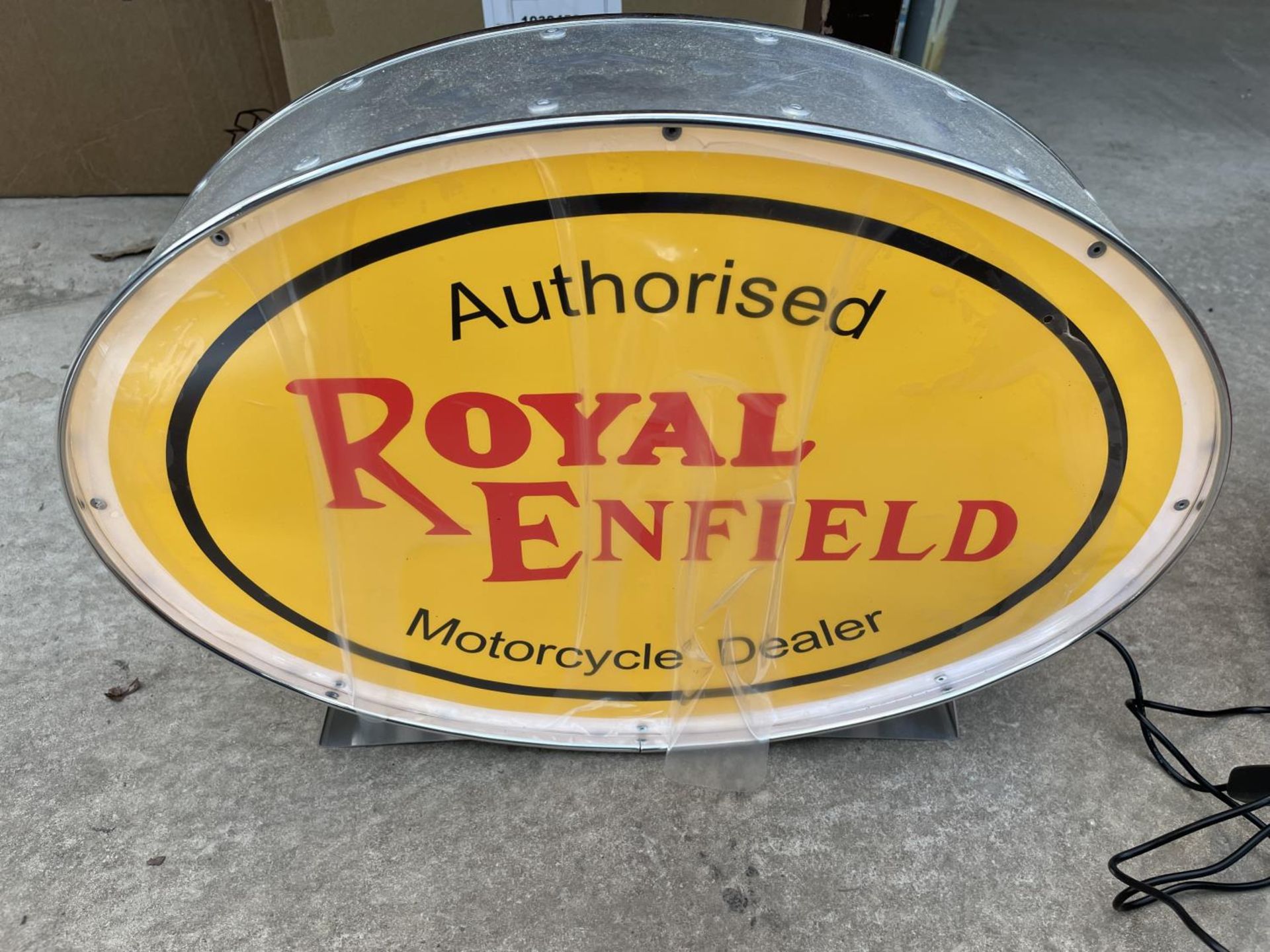 A ROYAL ENFIELD ILLUMINATED LIGHT BOX SIGN - WORKING ORDER AT TIME OF CATALOGUING. WIDTH 43.5CM,