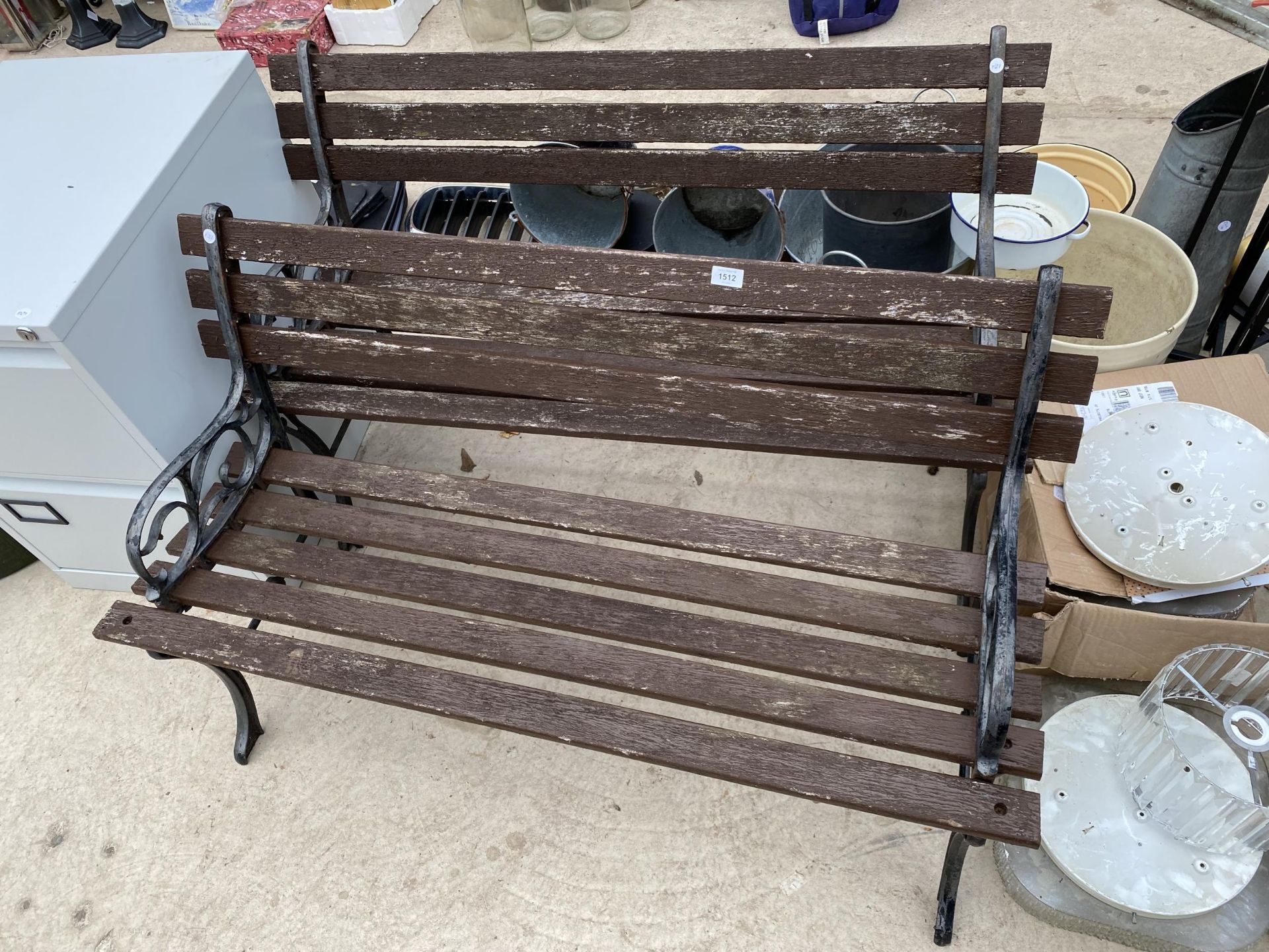 A PAIR OF WOODEN SLATTED GARDEN BENCHES WITH CAST BENCH ENDS