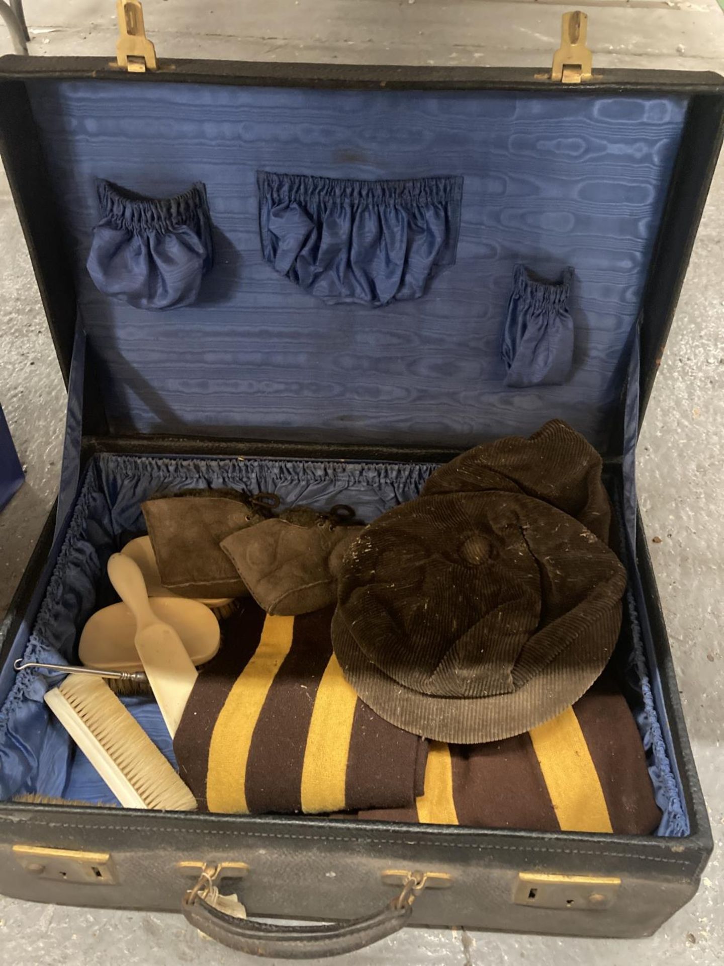 A VINTAGE SUITCASE CONTAINING VINTAGE BRUSHES WITH MONOGRAMS, CAPS, SCARVES, ETC