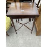 AN EDWARDIAN MAHOGANY AND CROSSBANDED FOLD-OVER GAMES TABLE, 27.5X18" OPENED