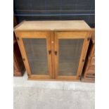 A MODERN BEECH TWO DOOR GLAZED CABINET