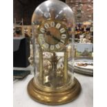 A GERMAN MANTLE CLOCK IN A GLASS DOME