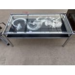 A MODERN TWO TIER COFFEE TABLE WITH GLASS TOP HAVING DRAGON DECORATION ON POLISHED CHROME FRAME,