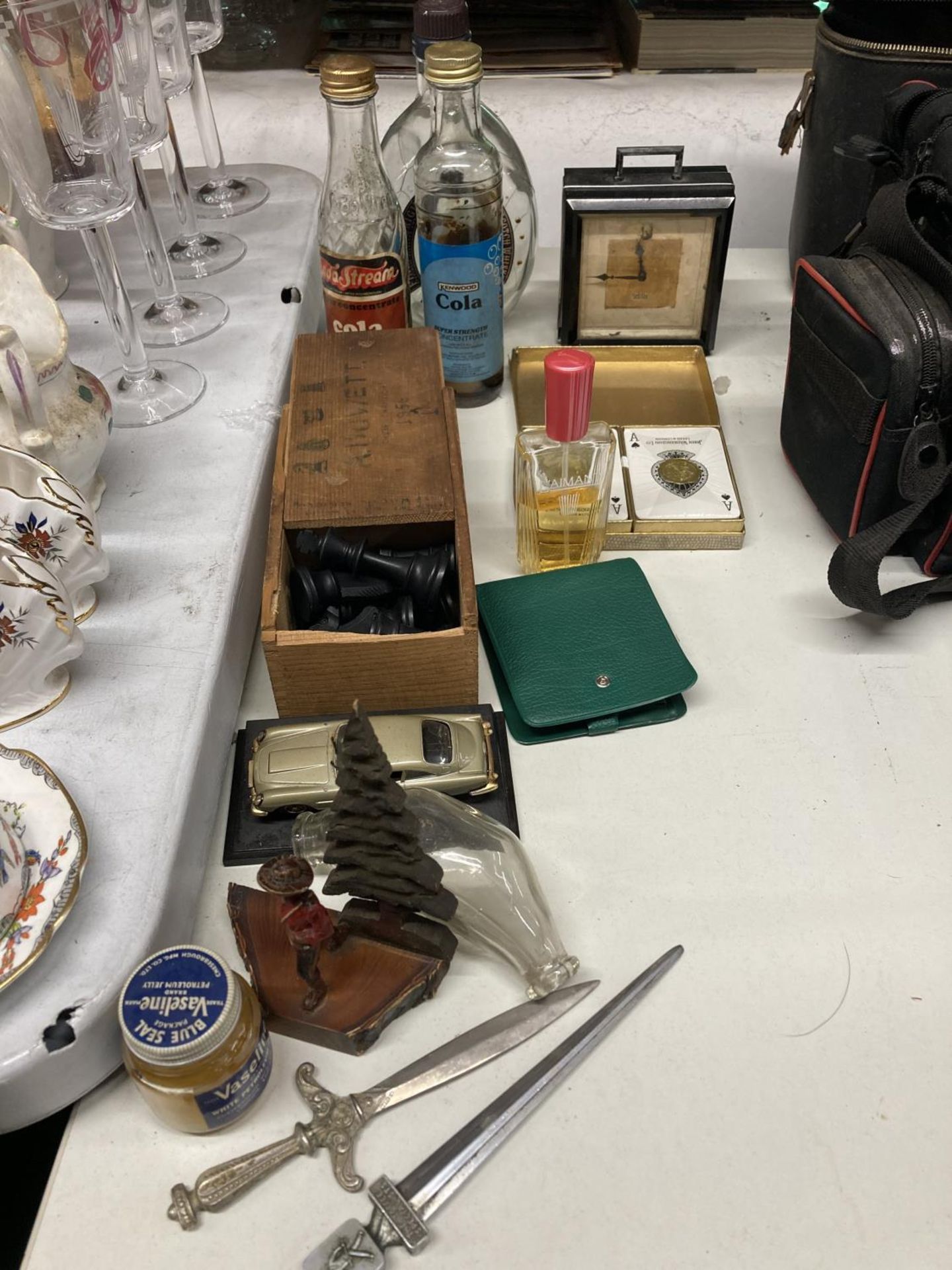 A QUANTITY OF ITEMS TO INCLUDE CHESS PIECES, PLAYING CARDS, BOTTLES, A CANADIAN FIGURE, ETC