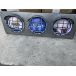 A FORD RS2000 ILLUMINATED LIGHT BOX SIGN WITH THREE IMAGES IN SEPERATE HEADLIGHT DESIGN- WORKING