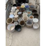 A LARGE QUANTITY OF CERAMIC AND WICKER PLANT POTS