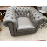 A MODERN GREY CHESTERFIELD STYLE EASY CHAIR