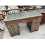 A 19TH CENTURY MAHOGANY KNEEHOLE DESK ENCLOSING EIGHT DRAWERS, ON BRACKET FEET WITH INSET LEATHER