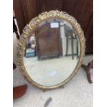 AN ORNATE OVAL GILT FRAMED MIRROR