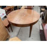 A RETRO TEAK 45" DIAMETER EXTENDING DINING TABLE ON TAPERING LEGS, WITH BRASS FEET