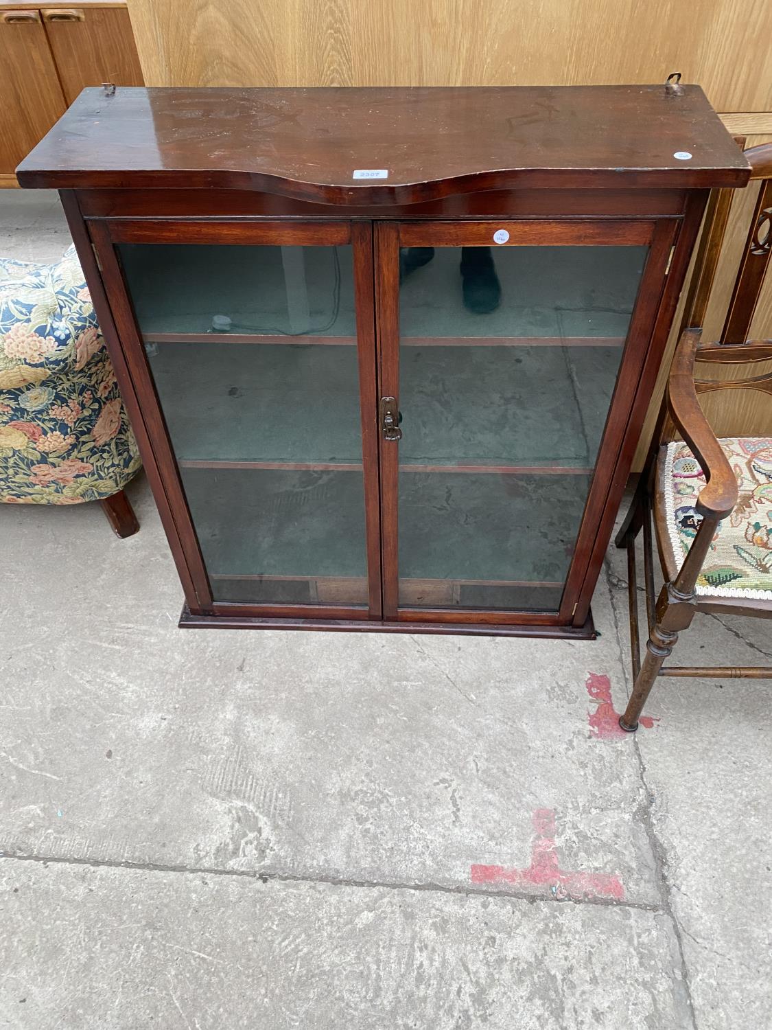 AN EDWARDIAN BOWFRONTED TWO DOOR GLAZED BOOKCASE, 34" WIDE