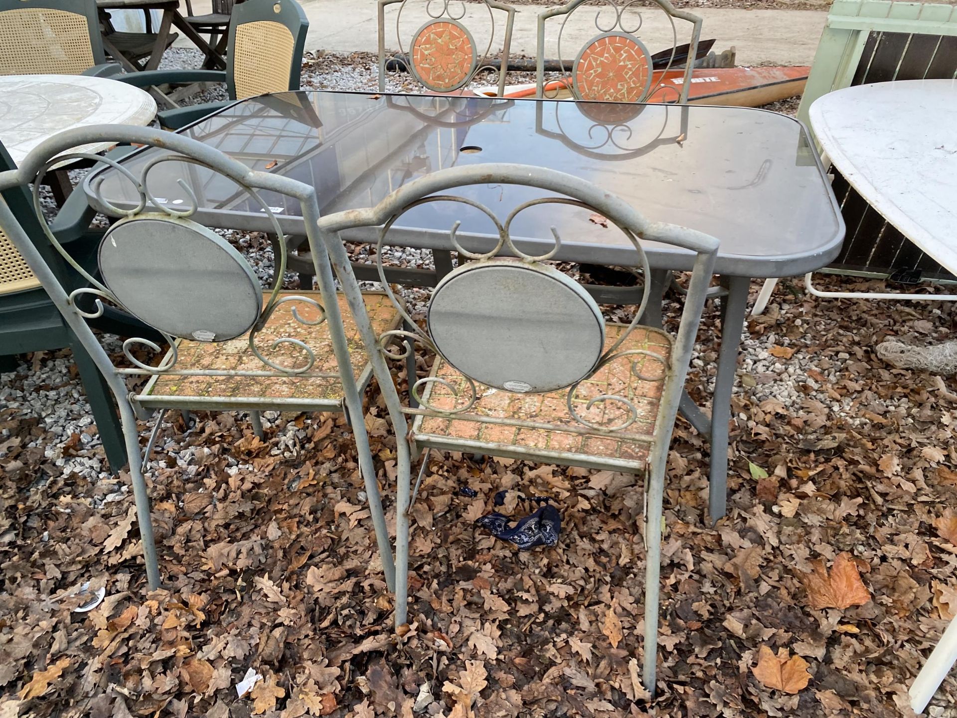 A GLASS TOPPED METAL GARDEN TABLE AND FOUR CHAIRS - Image 2 of 3
