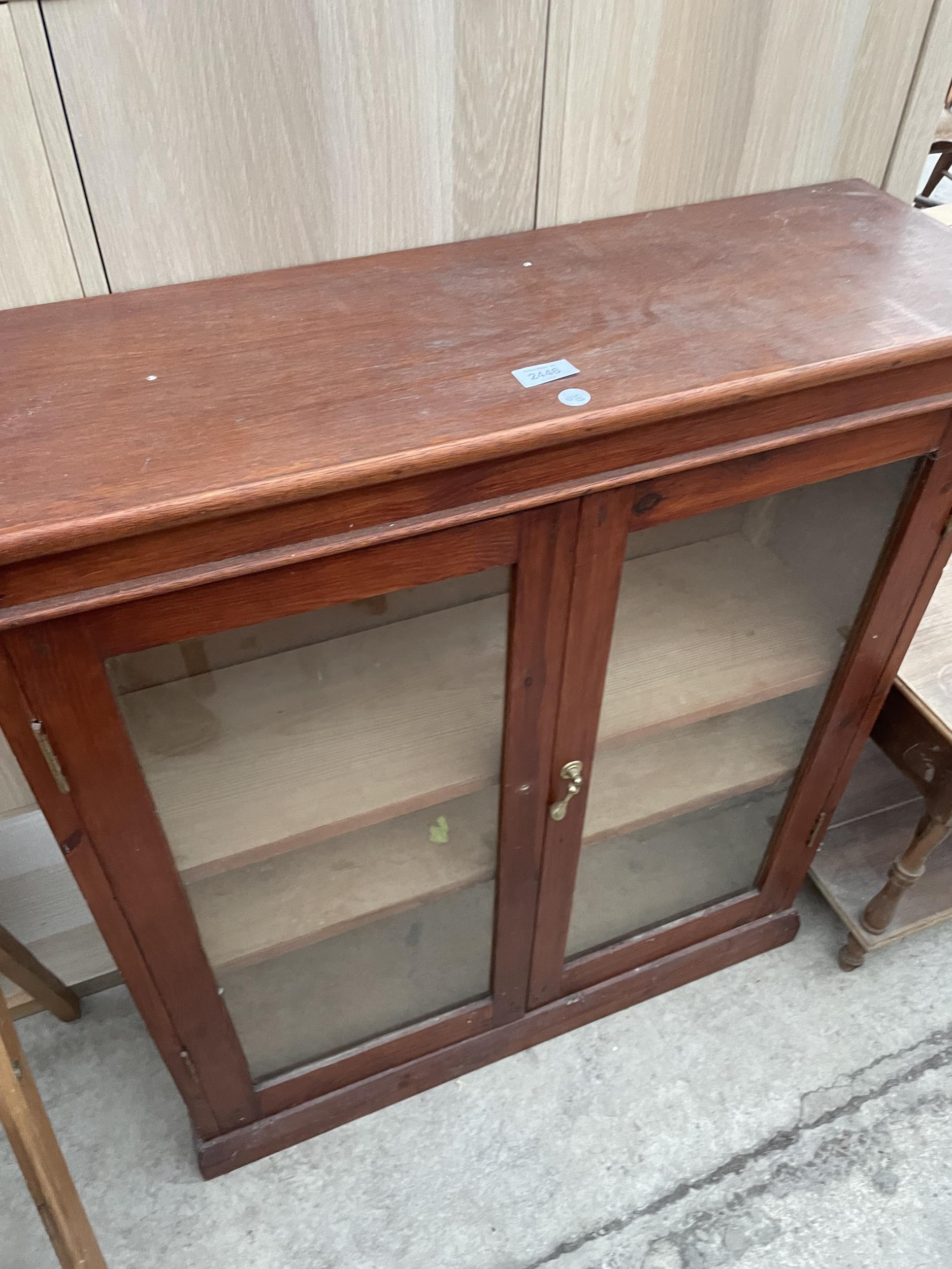 A 20TH CENTURY TWO DOOR GLAZED BOOKCASE, 32" WIDE, LOW BEDSIDE LOCKER AND TWO TIER OCCASIONAL TABLE - Image 2 of 5