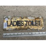A SMALL BRASS 'LADIES TOILET' SIGN (L:30CM)