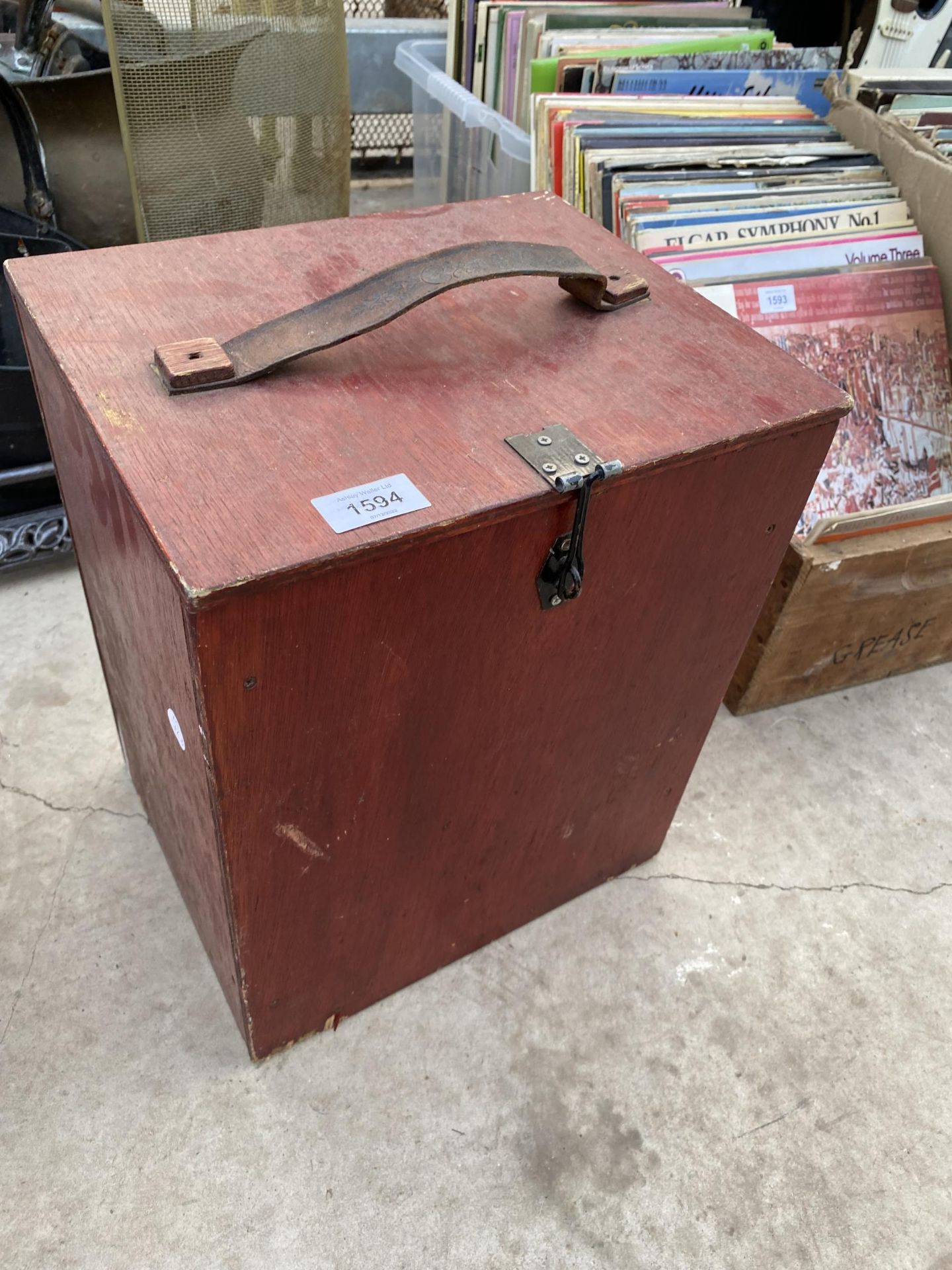 A WOODEN CARRY CASE WITH LEATHER STRAP HANDLE