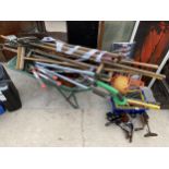 A LARGE ASSORTMENT OF GARDEN TOOLS TO INCLUDE A WHEEL BARROW, SHEARS AND HOES ETC