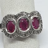 18 K GOLD RING 9.8 WITH 4 CENTRAL OVAL RUBIES FROM APPROXIMATELY 1.12 TOTAL CTS AND ROSETTE