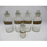 A collection of five vintage glass chemist bottles