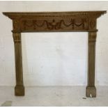 A 20th Century wooden fire surround with carved classical detail 140cm x 129cm