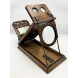 A Victorian walnut veneered Stereoscopic viewer with angled bed and sliding viewing platform