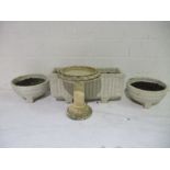 A conglomerate stone trough, a pair of matching planters and a bird bath