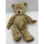 A large vintage straw filled mohair teddy with joined limbs approx. height 63cm