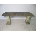 A concrete garden bench, with carved Squirrel supports