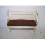 A white painted pine church pew