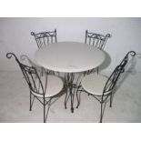 A wrought iron garden table and four chairs