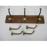 A collection of Victorian brass and ceramic coat hooks