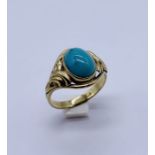 An 8ct gold (marked 333) ring set with a turquoise cabochon