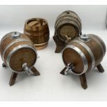 Four small barrels/kegs three on stands/legs