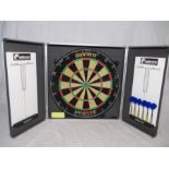 An Unicorn dartboard in wall hanging case and two sets of darts