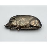 A hallmarked silver vesta case in the form of a recumbent pig