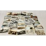 A collection of various vintage postcards along with a number of vintage photographs of various